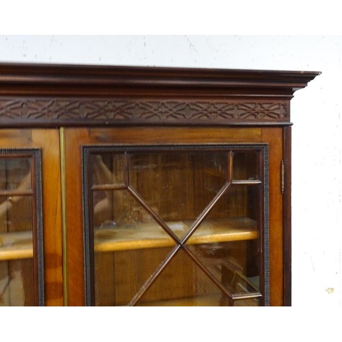 1438 - A late 19thC mahogany glazed bookcase by S & H Jewell, Queen Street, London. The cornice with blind ... 