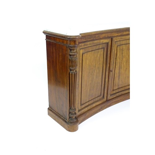 1440 - A 19thC mahogany marble topped sideboard of concave form, the marble top matching the castellated fr... 