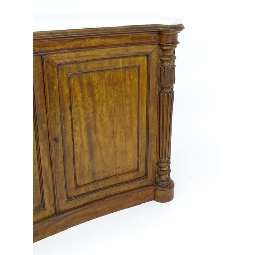 1440 - A 19thC mahogany marble topped sideboard of concave form, the marble top matching the castellated fr... 