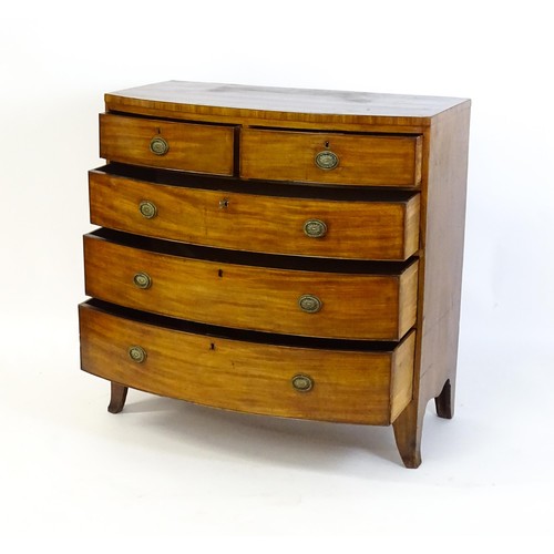 1471 - A late 18thC / early 19thC mahogany bow fronted chest of drawers with two short over three long grad... 