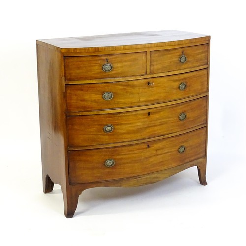 1471 - A late 18thC / early 19thC mahogany bow fronted chest of drawers with two short over three long grad... 