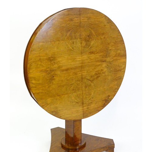 1472 - A 19thC walnut tilt top table of unusual proportions, with a circular table top above a canted pedes... 