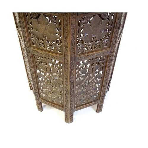 1474 - A late 19thC / early 20thC folding Islamic table with a floral carved top, brass inlay and the base ... 