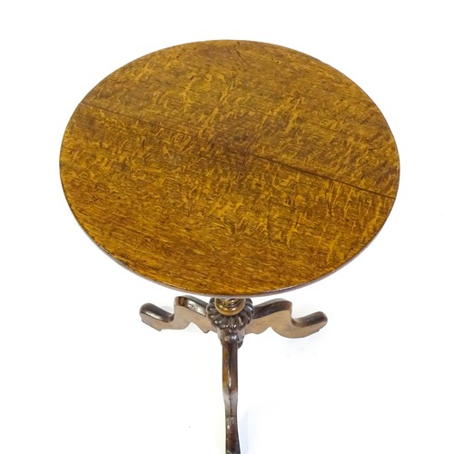 1475 - An early 20thC oak tripod table with a circular top above a turned tapering pedestal, a gadrooned lo... 