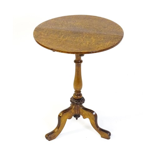 1475 - An early 20thC oak tripod table with a circular top above a turned tapering pedestal, a gadrooned lo... 