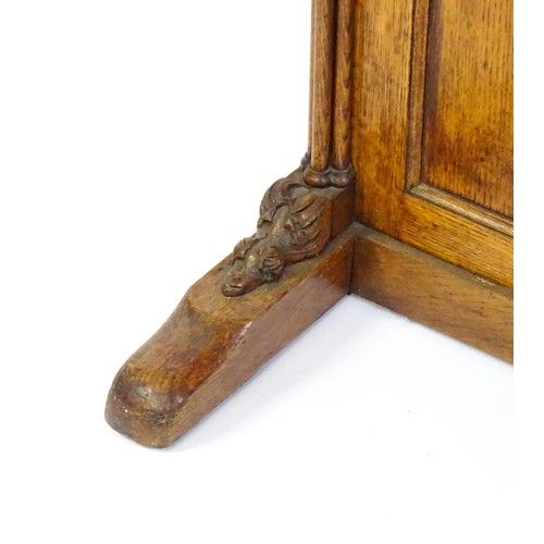 1480 - A 19thC oak Davenport with a leather inset writing slope above a panelled front and sides with Gothi... 
