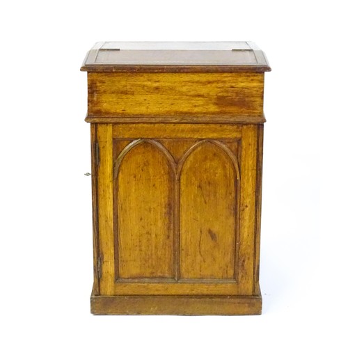 1480 - A 19thC oak Davenport with a leather inset writing slope above a panelled front and sides with Gothi... 