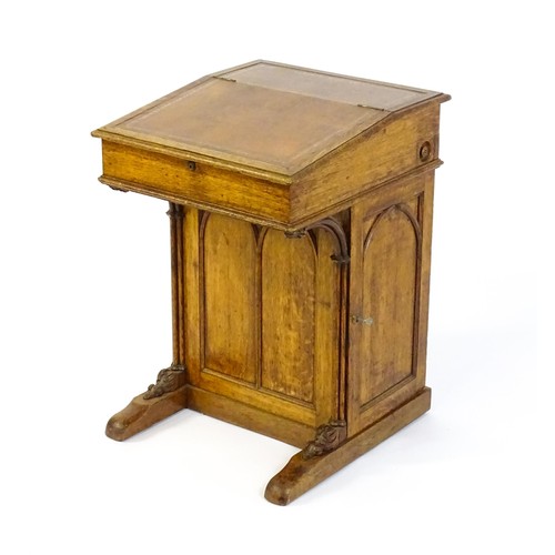 1480 - A 19thC oak Davenport with a leather inset writing slope above a panelled front and sides with Gothi... 