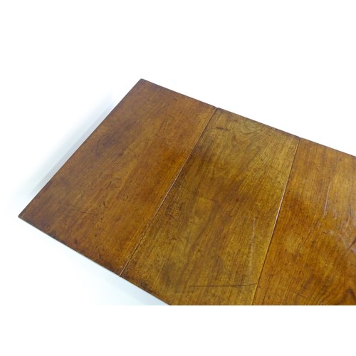 1483 - A Georgian mahogany drop flap table, with a rectangular top and two rectangular drop leaves, the tab... 