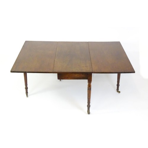 1483 - A Georgian mahogany drop flap table, with a rectangular top and two rectangular drop leaves, the tab... 