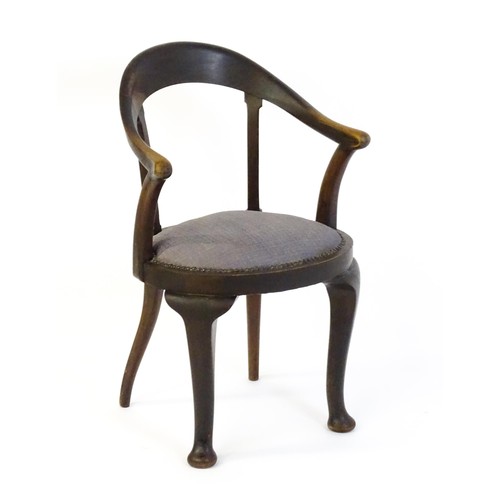 1485 - An early 20thC bow back armchair, with a shaped and bowed top rail above a circular seat and raised ... 