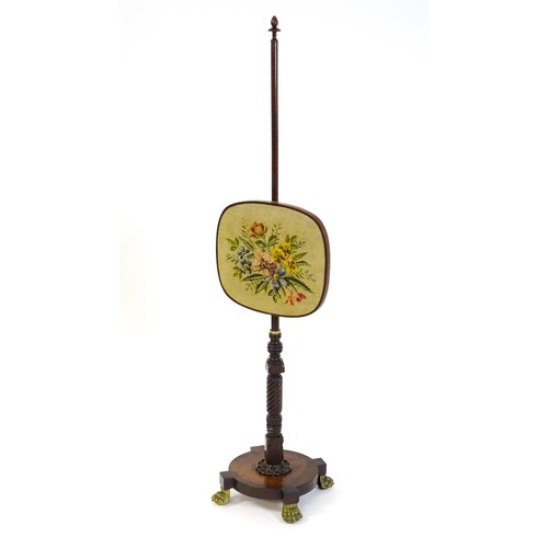 1489 - A mid 19thC rosewood pole screen, with an adjustable tapestry panel, a turned stem with coil detaili... 