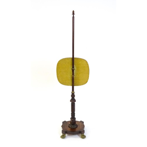 1489 - A mid 19thC rosewood pole screen, with an adjustable tapestry panel, a turned stem with coil detaili... 