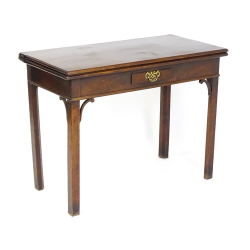 1490 - A late 18thC mahogany tea table with a hinged folding top above a small frieze drawer with a pierced... 