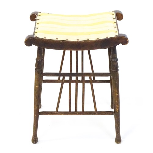 1494 - An early 20thC Aesthetic style stool in the Liberty style, with a concave top above four turned tape... 