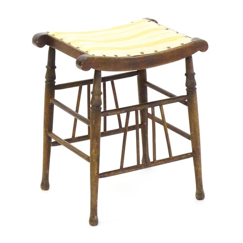 1494 - An early 20thC Aesthetic style stool in the Liberty style, with a concave top above four turned tape... 