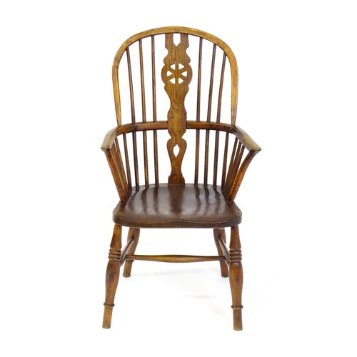 1517 - A 19thC double bow back Windsor chair with a pierced back splat, spindled backrest and a shaped seat... 