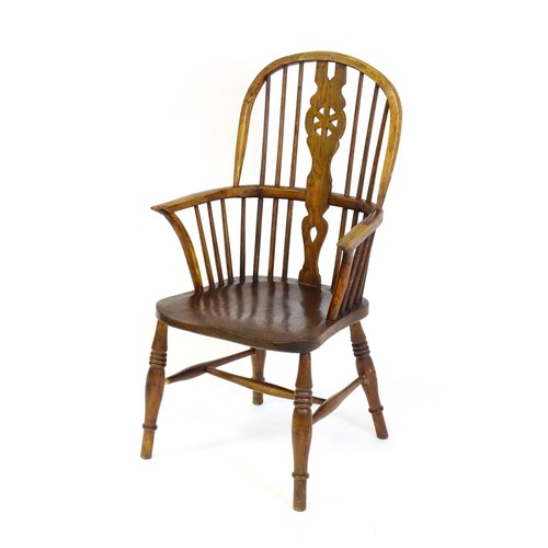 1517 - A 19thC double bow back Windsor chair with a pierced back splat, spindled backrest and a shaped seat... 