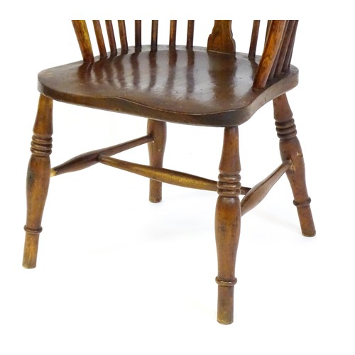 1517 - A 19thC double bow back Windsor chair with a pierced back splat, spindled backrest and a shaped seat... 