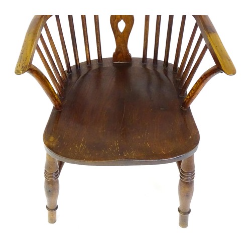 1517 - A 19thC double bow back Windsor chair with a pierced back splat, spindled backrest and a shaped seat... 