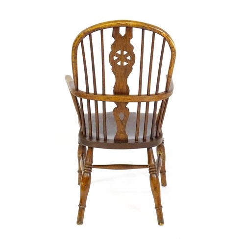 1517 - A 19thC double bow back Windsor chair with a pierced back splat, spindled backrest and a shaped seat... 