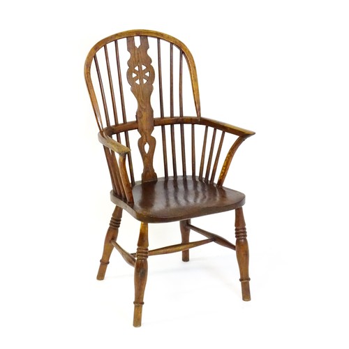 1517 - A 19thC double bow back Windsor chair with a pierced back splat, spindled backrest and a shaped seat... 