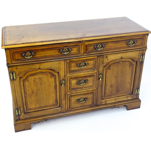 1519 - A 20thC sideboard / dresser base with a crossbanded top and two long over three short drawers flanke... 