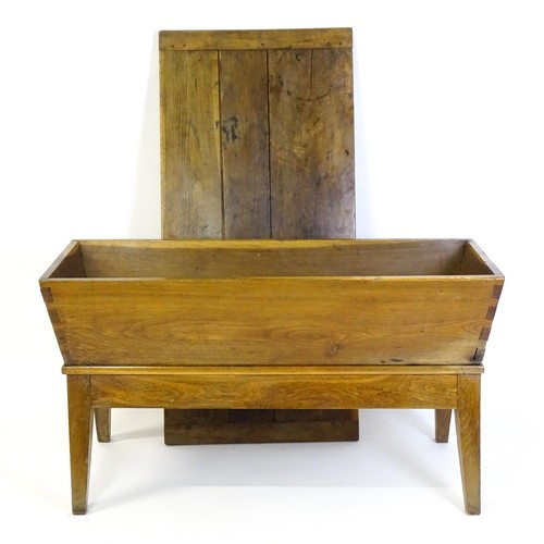 1521 - A late 19thC dough trough with a planked lid, exposed dovetailing to the frame and raised on four sp... 