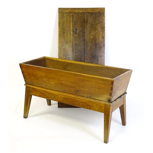 1521 - A late 19thC dough trough with a planked lid, exposed dovetailing to the frame and raised on four sp... 