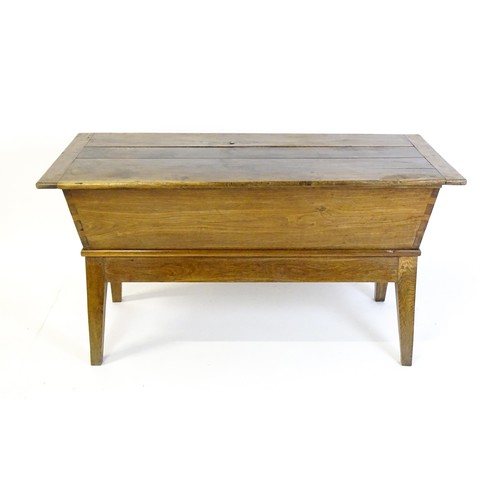 1521 - A late 19thC dough trough with a planked lid, exposed dovetailing to the frame and raised on four sp... 