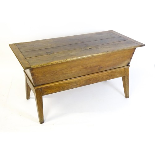 1521 - A late 19thC dough trough with a planked lid, exposed dovetailing to the frame and raised on four sp... 