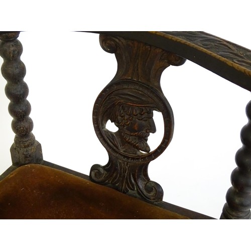 1522 - A late Georgian carved corner chair with inscribed Latin lettering, a drop in seat and raised on bob... 