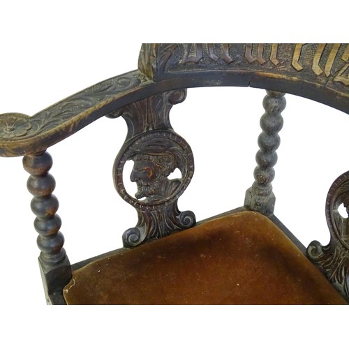 1522 - A late Georgian carved corner chair with inscribed Latin lettering, a drop in seat and raised on bob... 