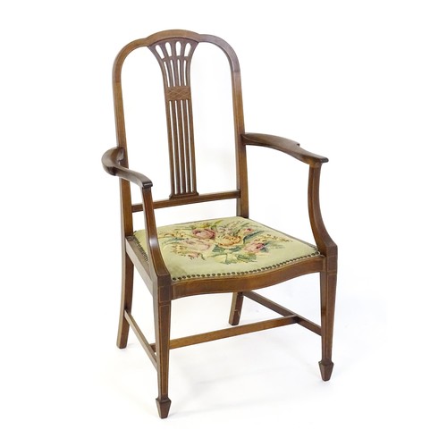 1523 - An early 20thC mahogany open armchair, with a shaped top rail, fanned and marquetry inlaid back spla... 