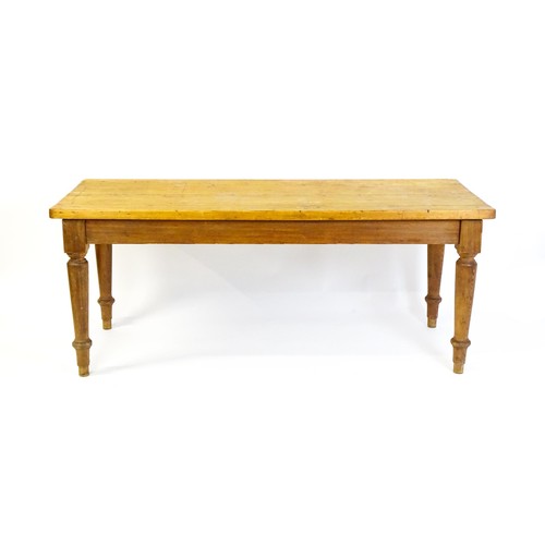 1524 - An Edwardian pine refectory / dining table  raised on four turned tapering legs. 72