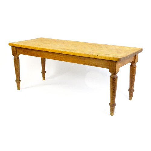 1524 - An Edwardian pine refectory / dining table  raised on four turned tapering legs. 72