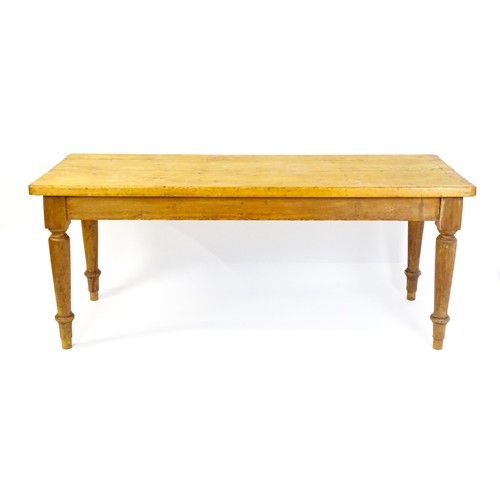 1524 - An Edwardian pine refectory / dining table  raised on four turned tapering legs. 72