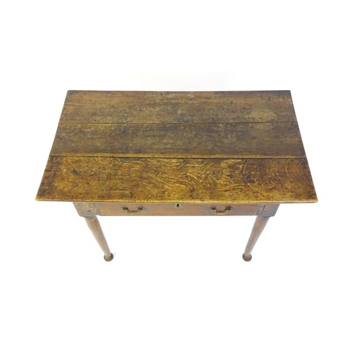 1526 - An 18thC oak side table with a three plank top above a single long drawer, the top raised on turned ... 