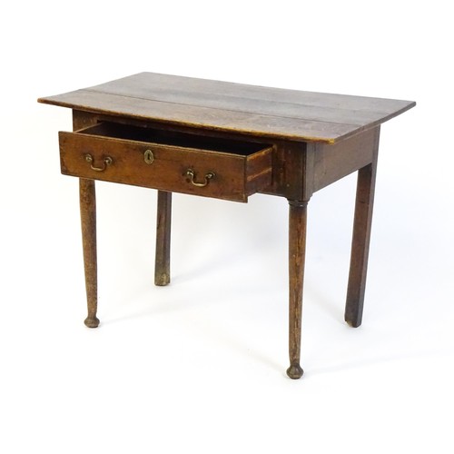 1526 - An 18thC oak side table with a three plank top above a single long drawer, the top raised on turned ... 