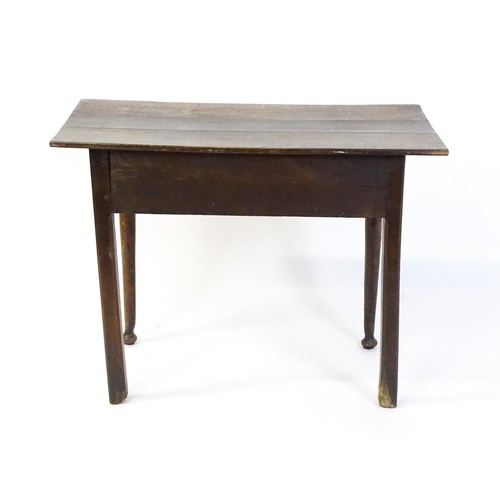 1526 - An 18thC oak side table with a three plank top above a single long drawer, the top raised on turned ... 