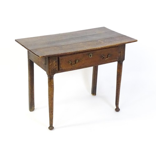 1526 - An 18thC oak side table with a three plank top above a single long drawer, the top raised on turned ... 