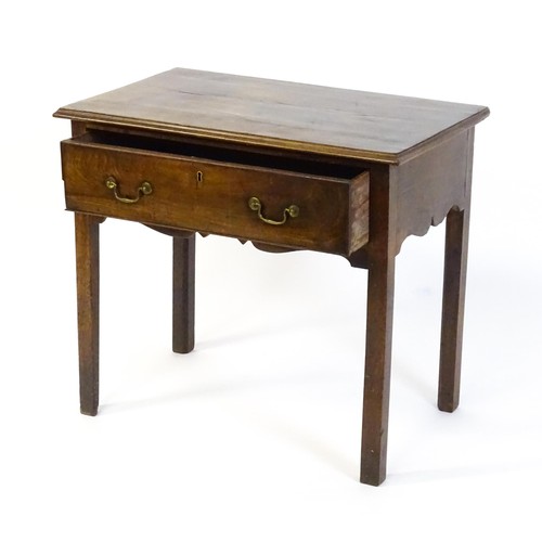 1527 - A Georgian mahogany low boy with a moulded top above a single long drawer with swan neck handles, th... 