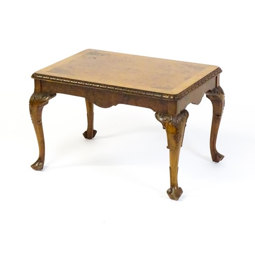 1530 - A mid / late 20thC coffee table with a burr walnut veneered top, with an egg and dart moulded edge a... 