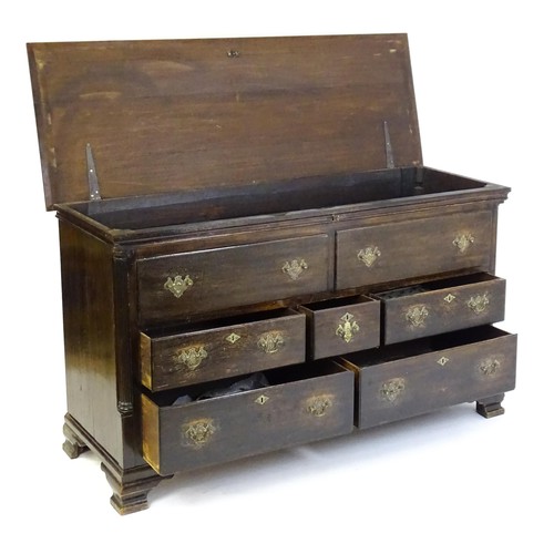 1535 - A mid / late 18thC oak mule chest with a moulded lid above two false drawers and five short drawers ... 