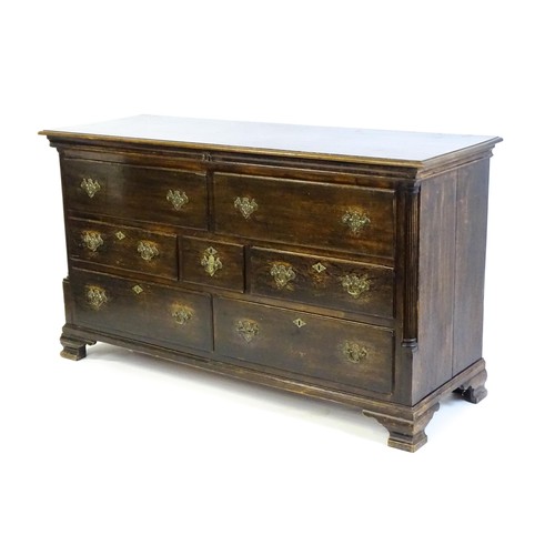 1535 - A mid / late 18thC oak mule chest with a moulded lid above two false drawers and five short drawers ... 