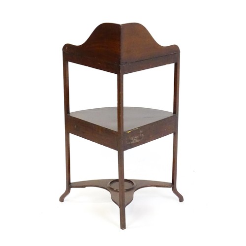 1541 - A Georgian mahogany washstand with a shaped upstand, three tiers and a single short drawer raised on... 