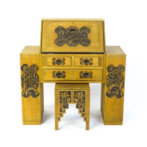 1547 - An early / mid 20thC Teak bureau accompanied by a stool, with carved oriental scenes to the front, d... 