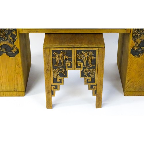 1547 - An early / mid 20thC Teak bureau accompanied by a stool, with carved oriental scenes to the front, d... 