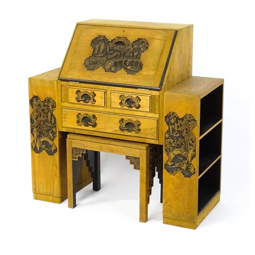 1547 - An early / mid 20thC Teak bureau accompanied by a stool, with carved oriental scenes to the front, d... 