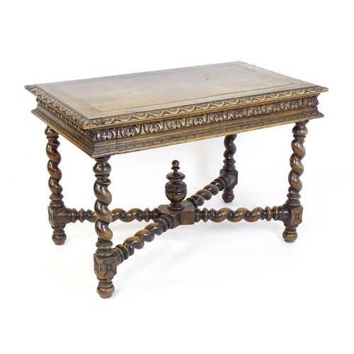 1548 - A late 19thC oak side table with a carved outer rim and single long drawer raised on barley twist le... 